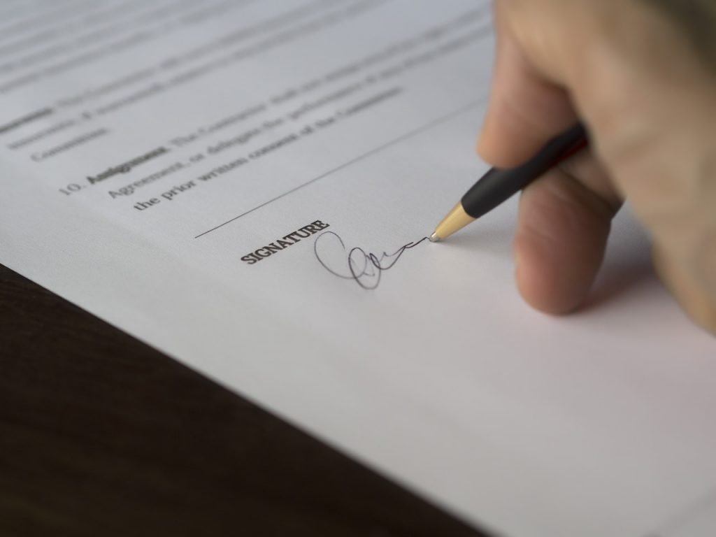 Hand signing a document
